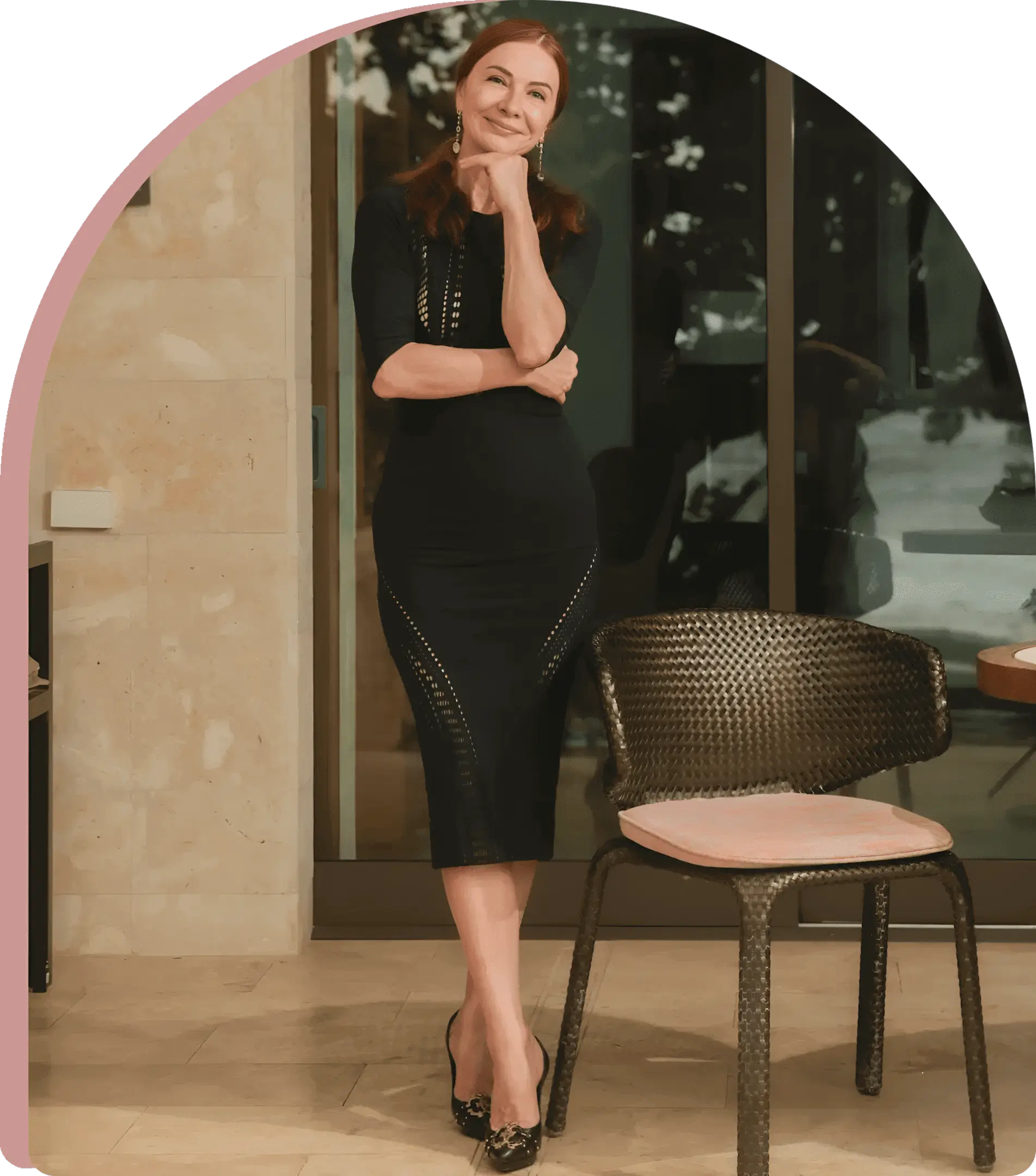 Confident woman in black dress by chair